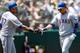 OAKLAND, CA - AUGUST 03: Leonys Martin #2 of the Texas Rangers is congratulated by Nelson Cruz #17 after Martin scored against the Oakland Athletics in the third inning at O.co Coliseum on August 3, 2013 in Oakland, California. (Photo by Thearon W. Hend