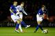 LEICESTER, ENGLAND - DECEMBER 17: Edin Dzeko of Manchester City shoots past Gary Taylor-Fletcher (L) and Ignasi Miquel of Leicester City (R) during the Capital One Cup Quarter-Final match between Leicester City and Manchester City at The King Power Stadi