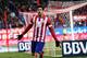 MADRID, SPAIN - DECEMBER 15: Diego Costa of Club Atletico de Madrid celebrates after scoring Atletico's 3rd goal during the La Liga match between Club Atletico de Madrid and Valencia CF at Vicente Calderon Stadium on December 15, 2013 in Madrid, Spain.