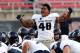 LAS VEGAS, NV - NOVEMBER 09: Paul Piukala #48 of the Utah State Aggies rallies his teammates before their game against the UNLV Rebels at Sam Boyd Stadium on November 9, 2013 in Las Vegas, Nevada. Utah State won 28-24. (Photo by Ethan Miller/Getty Image