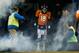 DENVER, CO - DECEMBER 12: Quarterback Peyton Manning #18 of the Denver Broncos emerges from the tunnel during player introductions before a game against the San Diego Chargers at Sports Authority Field Field at Mile High on December 12, 2013 in Denver, C