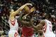 HOUSTON, TX - DECEMBER 18: Luol Deng #9 of the Chicago Bulls drives with the ball against Francisco Garcia #32 and James Harden #13 of the Houston Rockets during the game at Toyota Center on December 18, 2013 in Houston, Texas. NOTE TO USER: User express