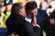 LIVERPOOL, ENGLAND - DECEMBER 21: Cardiff City manager Malky Mackay (R) talks with Liverpool manager Brendan Rogers (L) before the Barclays Premier League match between Liverpool and Cardiff City at Anfield on December 21, 2013 in Liverpool, England. (P