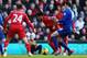 LIVERPOOL, ENGLAND - DECEMBER 21: Luis Suarez of Liverpool is tackled by Jordon Mutch of Cardiff City during the Barclays Premier League match between Liverpool and Cardiff City at Anfield on December 21, 2013 in Liverpool, England. (Photo by Clive Brun