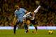 LONDON, ENGLAND - DECEMBER 21: Vincent Kompany of Manchester City tackles Adel Taarabt of Fulham during the Barclays Premier League match between Fulham and Manchester City at Craven Cottage on December 21, 2013 in London, England. (Photo by Clive Rose/