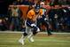 DENVER, CO - DECEMBER 12: Quarterback Peyton Manning #18 of the Denver Broncos scrambles out of the pocket against the San Diego Chargers at Sports Authority Field Field at Mile High on December 12, 2013 in Denver, Colorado. (Photo by Dustin Bradford/Get