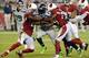 GLENDALE, AZ - OCTOBER 17: Marshawn Lynch #24 of the Seattle Seahawks runs through the tackles of Patrick Peterson #21 and Jerraud Powers #25 of the Arizona Cardinals at University of Phoenix Stadium on October 17, 2013 in Glendale, Arizona. (Photo by N