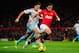 MANCHESTER, ENGLAND - DECEMBER 21: Javier Hernandez of Manchester United competes with James Tomkins of West Ham United during the Barclays Premier League match between Manchester United and West Ham United at Old Trafford on December 21, 2013 in Manches