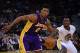 December 21, 2013; Oakland, CA, USA; Los Angeles Lakers small forward Nick Young (0) dribbles against Golden State Warriors small forward Harrison Barnes (40) during the second quarter at Oracle Arena. Mandatory Credit: Kyle Terada-USA TODAY Sports