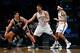Nov 5, 2013; Brooklyn, NY, USA; Utah Jazz center Enes Kanter (0) looks to drive past Brooklyn Nets center Brook Lopez (11) and point guard Deron Williams (8) during the first quarter at Barclays Center. Mandatory Credit: Anthony Gruppuso-USA TODAY Sports