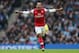 MANCHESTER, ENGLAND - DECEMBER 14: Theo Walcott of Arsenal celebrates after scoring his first goal during the Barclays Premier League match between Manchester City and Arsenal at Etihad Stadium on December 14, 2013 in Manchester, England. (Photo by Cli