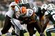 EAST RUTHERFORD, NJ - DECEMBER 22: Edwin Baker #27 of the Cleveland Browns tries to get free of Sheldon Richardson #91 of the New York Jets during their game at MetLife Stadium on December 22, 2013 in East Rutherford, New Jersey. (Photo by Jeff Zelevan