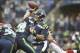 Dec 22, 2013; Seattle, WA, USA; Seattle Seahawks quarterback Russell Wilson (3) passes against the Arizona Cardinals during the first quarter at CenturyLink Field. Mandatory Credit: Joe Nicholson-USA TODAY Sports