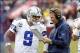 Dec 22, 2013; Landover, MD, USA; Dallas Cowboys quarterback Tony Romo (9) talks with Cowboys head coach Jason Garrett (R) during a timeout against the Washington Redskins in the fourth quarter at FedEx Field. The Cowboys won 24-23. Mandatory Credit: Geoff