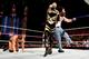 Luke Harper hits Goldust with a clothesline.