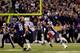 BALTIMORE, MD - DECEMBER 22: Quarterback Joe Flacco #5 of the Baltimore Ravens gets off a pass while being hit by outside linebacker Dont'a Hightower #54 of the New England Patriots during the second half at M&T Bank Stadium on December 22, 2013 in Baltim