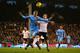 LONDON, ENGLAND - DECEMBER 21: Edin Dzeko of Manchester City and Sascha Riether of Fulham battle for the ball during the Barclays Premier League match between Fulham and Manchester City at Craven Cottage on December 21, 2013 in London, England. (Photo