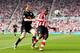 SUNDERLAND, ENGLAND - APRIL 23: Asamoah Gyan of Sunderland (R) in action with Gary Caldwell of Wigan during the Barclays Premier League match between Sunderland and Wigan Athletic at Stadium of Light on April 23, 2011 in Sunderland, England. (Photo by S