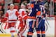 DETROIT, MI - DECEMBER 23: Matt Martin #17 and Colin McDonald #13 of the New York Islanders hug teammate Casey Cizikas #53 after scoring a goal as Luke Glendening #41 and Petr Mrazek #34 of the Detroit Red Wings can only watch during an NHL game at Joe Lo