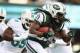 EAST RUTHERFORD, NJ - DECEMBER 01: Chris Ivory #33 of the New York Jets runs with the ball as Koa Misi #55 of the Miami Dolphins trails during their game at MetLife Stadium on December 1, 2013 in East Rutherford, New Jersey. (Photo by Al Bello/Getty I