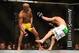 Jul. 7, 2012; Las Vegas, NV, USA; UFC fighter Anderson Silva (left) watches as Chael Sonnen falls to the ground during a middleweight bout in UFC 148 at the MGM Grand Garden Arena. Mandatory Credit: Mark J. Rebilas-USA TODAY Sports