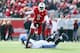 LOUISVILLE, KY - NOVEMBER 23: Teddy Bridgewater #5 of the Louisville Cardinals avoids the tackle of Chase Rome #47 of the Memphis Tigers at Papa John's Cardinal Stadium on November 23, 2013 in Louisville, Kentucky. (Photo by Andy Lyons/Getty Images)