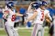 DETROIT, MI - DECEMBER 22: Josh Brown #3 of the New York Giants celebrates his overtime game winning filed goal to beat the Detroit Lions 23-20 with Steve Weatherford #5 and Bear Pascoe #86 while playing the Detroit Lions at Ford Field on December 22, 201