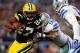 ARLINGTON, TX - DECEMBER 15: Running back Eddie Lacy #27 of the Green Bay Packers runs with the ball as defensive end George Selvie #99 of the Dallas Cowboys defends during a game at AT&T Stadium on December 15, 2013 in Arlington, Texas. (Photo by Tom P