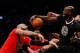 Dec 25, 2013; Brooklyn, NY, USA; Brooklyn Nets point guard Deron Williams (right) fouls Chicago Bulls power forward Carlos Boozer (left) as power forward Kevin Garnett (middle) reaches for the ball during the first quarter at Barclays Center. Mandatory C