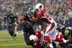 SEATTLE - DECEMBER 22: Marshawn Lynch #24 of the Seattle Seahawks is stopped short of a touchdown by Daryl Washington #58 and Marcus Bernard #59 of the Arizona Cardinals on December 22, 2013 at CenturyLink Field in Seattle, Washington. (Photo by Jonatha