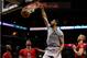 Dec 25, 2013; San Antonio, TX, USA; San Antonio Spurs forward Tim Duncan (21) dunks as Houston Rockets center Dwight Howard (left) looks on during the first half at AT&T Center. Mandatory Credit: Soobum Im-USA TODAY Sports