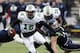 HOUSTON, TX - DECEMBER 07: Rakeem Cato #12 of the Marshall Thundering Herd scrambles out of the pocket as he gets a block from Garrett Scott #76 against the Rice Owls at Rice Stadium on December 7, 2013 in Houston, Texas. (Photo by Bob Levey/Getty Image
