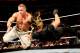 John Cena bowls over Seth Rollins.