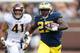 ANN ARBOR, MI - AUGUST 31: Derrick Green #27 of the Michigan Wolverines finds some open space while playing Justin Cherocci #41 and the Central Michigan Chippewas at Michigan Stadium on August 31, 2013 in Ann Arbor, Michigan. (Photo by Gregory Shamus/Get