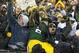Dec 22, 2013; Green Bay, WI, USA; Green Bay Packers running back Eddie Lacy (27) celebrates a touchdown by jumping into the stands during the second quarter against the Pittsburgh Steelers at Lambeau Field. Mandatory Credit: Jeff Hanisch-USA TODAY Sports