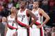 PORTLAND, OR - NOVEMBER 25: Damian Lillard #0, Wesley Matthews #2 and Nicolas Batum #88 of the Portland Trail Blazers stand on the court against the New York Knicks on November 25, 2013 at the Moda Center Arena in Portland, Oregon. NOTE TO USER: User exp
