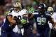 SEATTLE, WA - DECEMBER 02: Tight end Jimmy Graham #80 of the New Orleans Saints is tackled by outside linebacker K.J. Wright #50 and defensive tackle Tony McDaniel #99 of the Seattle Seahawks during a game at CenturyLink Field on December 2, 2013 in Seat