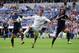 MADRID, SPAIN - OCTOBER 19: Cristiano Ronaldo (C) of Real Madrid CF is tackled by Wellington Silva (L) and Sergio Sanchez of Malaga CF during the La Liga match between Real Madrid CF and Malaga CF at the Santiago Bernabeu stadium on October 19, 2013 in M