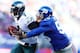 EAST RUTHERFORD, NJ - DECEMBER 30: Michael Vick #7 of the Philadelphia Eagles is pushed out of bounds by Keith Rivers #55 of the New York Giants at MetLife Stadium on December 30, 2012 in East Rutherford, New Jersey. (Photo by Elsa/Getty Images)