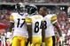 GLENDALE, AZ - OCTOBER 23: Mike Wallace #17 of the Pittsburgh Steelers celebrates his 95-yard touchdown with teammates Antonio Brown #84 and Isaac Redman #33 during the second quarter against the Arizona Cardinals at University of Phoenix Stadium on O