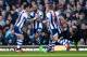 LONDON, ENGLAND - DECEMBER 28: Nicolas Anelka of West Brom touches his sleeve as he celebrates scoring their first goal during the Barclays Premier League match between West Ham United and West Bromwich Albion at Boleyn Ground on December 28, 2013 in Lon