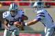 LUBBOCK, TX - NOVEMBER 9: Quarterback Jake Waters #15 of the Kansas State Wildcats hands the ball to John Hubert #33 of the Kansas State Wildcats during game action against the Texas tech Red Raiders on November 9, 2013 at AT&T Jones Stadium in Lubbock,