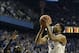 Dec 28, 2013; Lexington, KY, USA; Kentucky Wildcats guard Andrew Harrison (5) shoots against Louisville Cardinals forward/center Mangok Mathiang (12) during the first half at Rupp Arena. Mandatory Credit: Jamie Rhodes-USA TODAY Sports