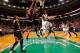 BOSTON, MA - JANUARY 18: Rajon Rondo #9 of the Boston Celtics goes under Joakim Noah #13 and Carlos Boozer #5 of the Chicago Bulls before attempting a shot during the game on January 18, 2013 at TD Garden in Boston, Massachusetts. NOTE TO USER: User expr