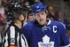 TORONTO, ON - DECEMBER 21: Dion Phaneuf #3 of the Toronto Maple Leafs talks with Referee Marc Joanette during a break in NHL game action against the Detroit Red Wings December 21, 2013 at the Air Canada Centre in Toronto, Ontario, Canada. (Photo by Graig