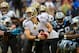 Dec 22, 2013; Charlotte, NC, USA; New Orleans Saints quarterback Drew Brees (9) is sacked as Carolina Panthers defensive end Greg Hardy (76) comes from the left and cornerback Captain Munnerlyn (41) holds Brees's jersey and free safety Mike Mitchell (21)