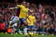 LONDON, ENGLAND - DECEMBER 26: Theo Walcott of Arsenal is chased by Kevin Nolan of West Ham United during the Barclays Premier League match between West Ham United and Arsenal at Boleyn Ground on December 26, 2013 in London, England. (Photo by Bryn Lenn