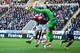 NEWCASTLE UPON TYNE, ENGLAND - DECEMBER 29: Per Mertesacker of Arsenal challenges for a header as Tim Krul of Newcastle United punches clear during the Barclays Premier League match between Newcastle United and Arsenal at St James' Park on December 29, 20