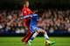 LONDON, ENGLAND - DECEMBER 29: Willian of Chelsea holds off the challenge from Lucas Leiva of Liverpool during the Barclays Premier League match between Chelsea and Liverpool at Stamford Bridge on December 29, 2013 in London, England. (Photo by Clive Ro
