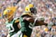 GREEN BAY, WI - OCTOBER 06: Mike Neal #96 of the Green Bay Packers reacts with A.J. Hawk #50 to a stop of Reggie Bush #21 of the Detroit Lions for a loss during the first quarter at Lambeau Field on October 6, 2013 in Green Bay, Wisconsin. (Photo by Har